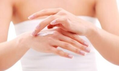 girl applying ointment on her hand